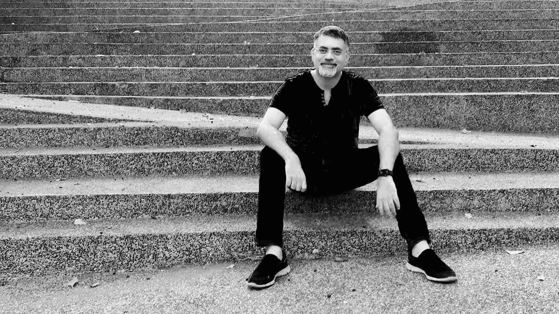 Architect Harshal Shinde seated on broad outdoor steps