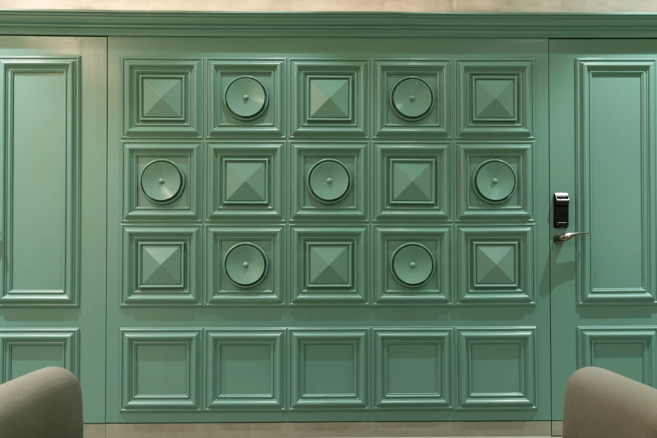 Custom green wall panelling and furniture detail