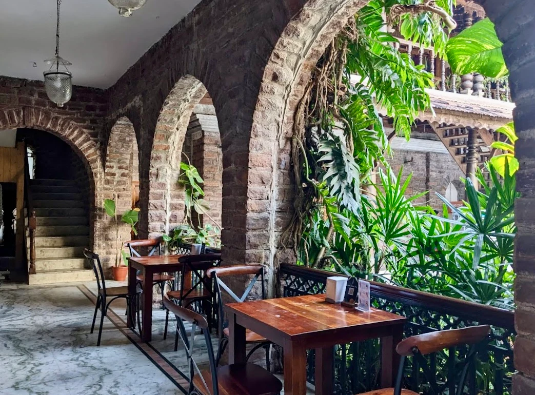 Dining terrace framed by stone arches