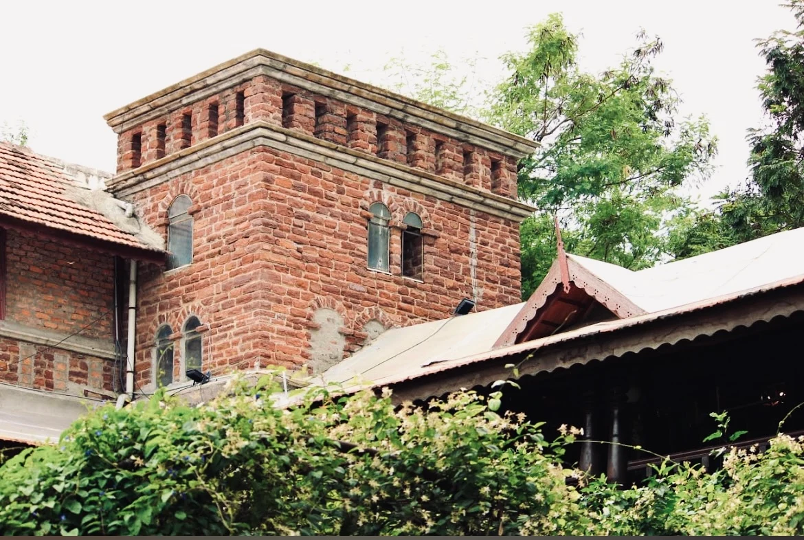 Stone tower and planted courtyard at BRR Residence