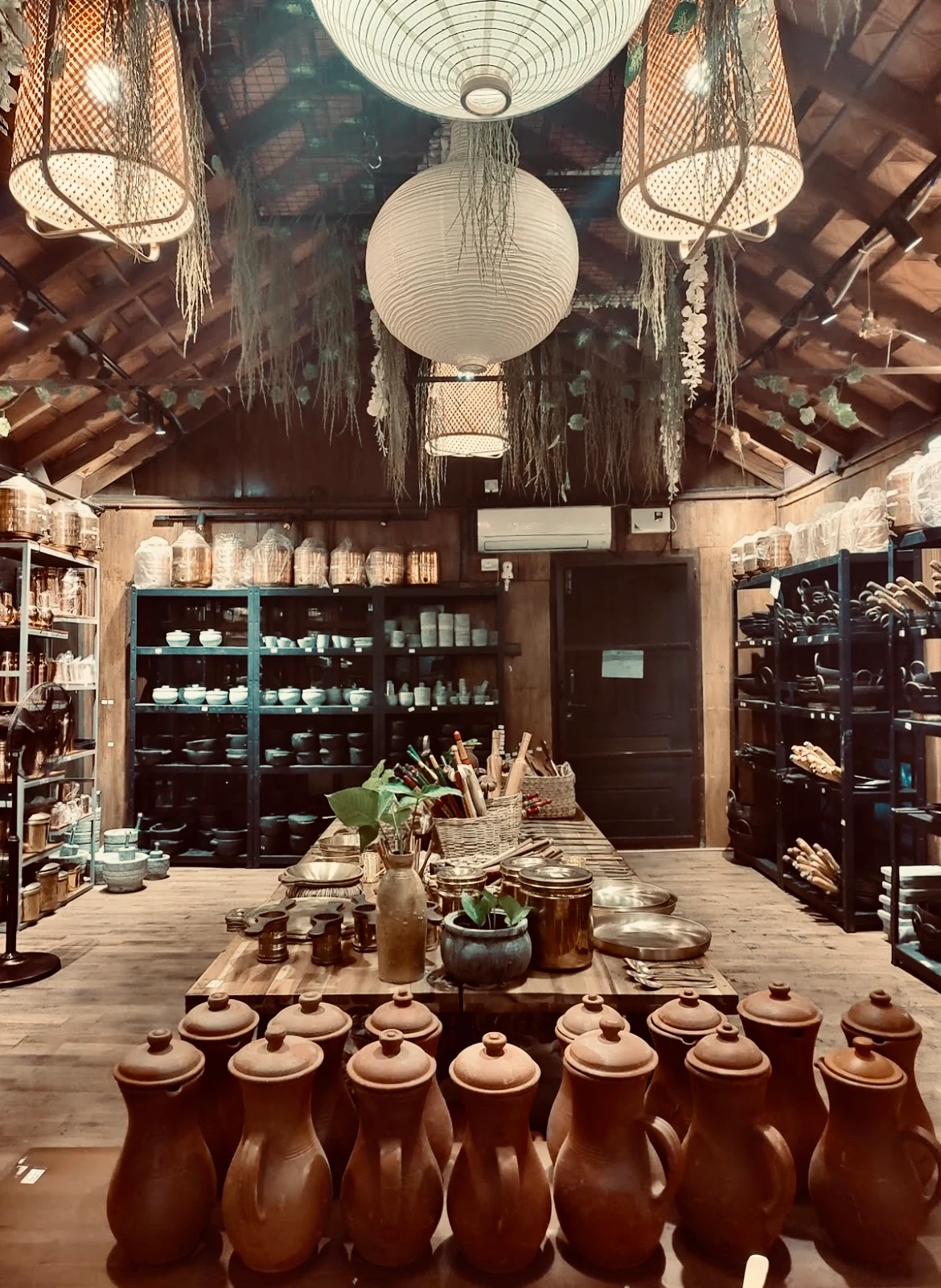 Interior display and handcrafted lighting beneath a timber ceiling