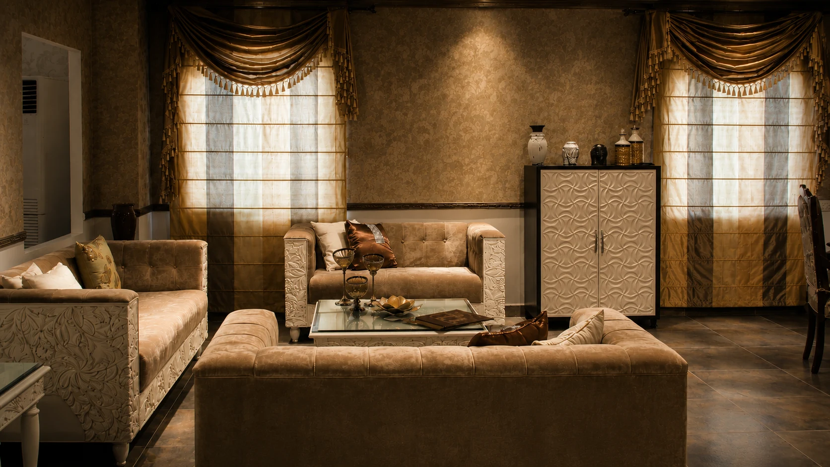 Warmly lit living room with carved furniture